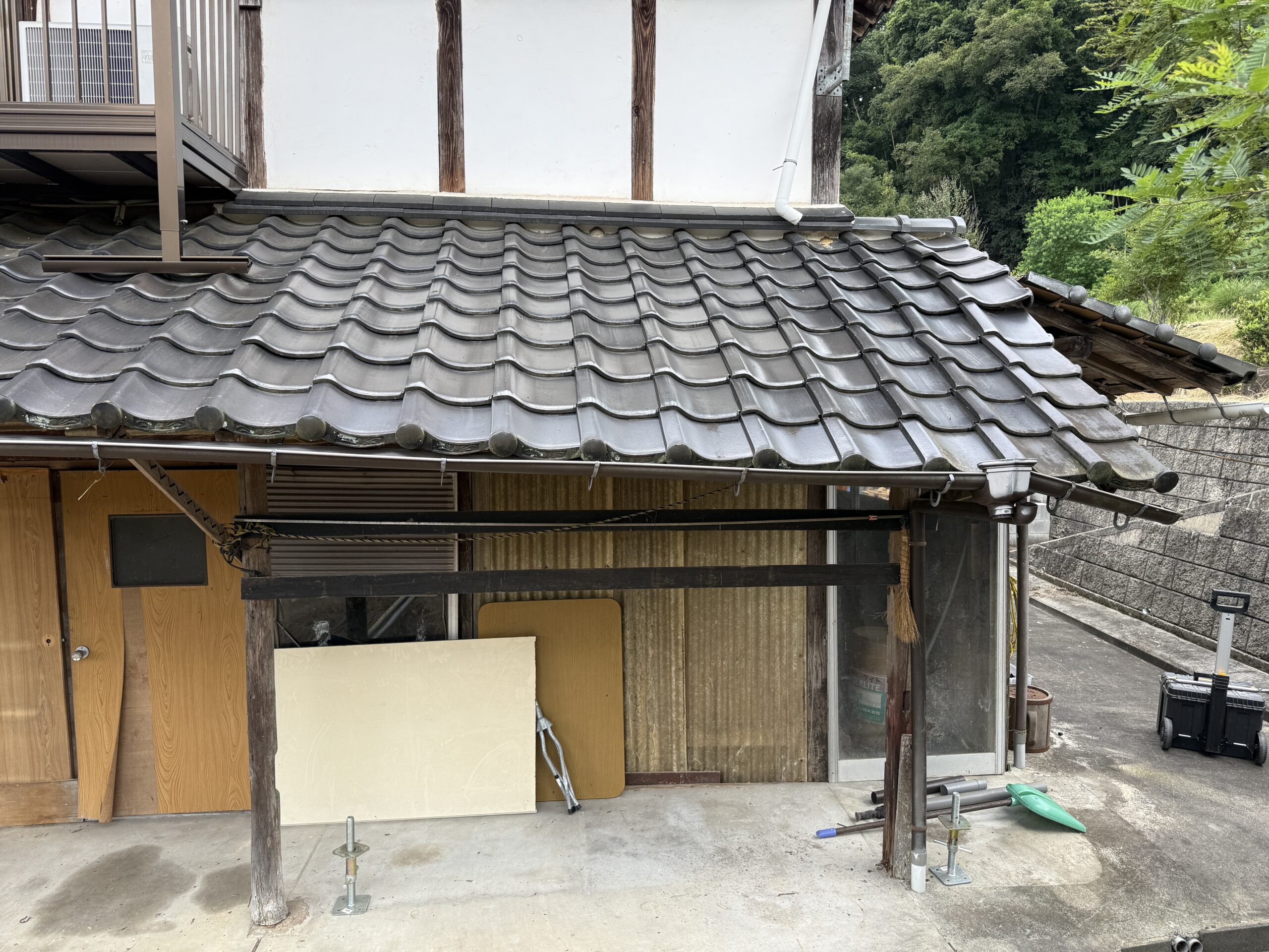 勝手口の既存小屋根。長年の使用で下地が傷んできた状態